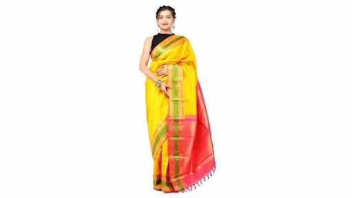 Indian woman wearing a bright yellow silk saree with a contrasting pink and green woven border, golden detailing and a matching sleeveless blouse.